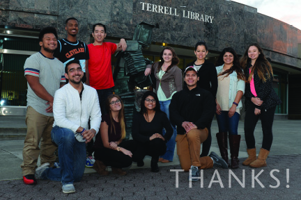 Several students standing around Book Man in front of Terrell Library