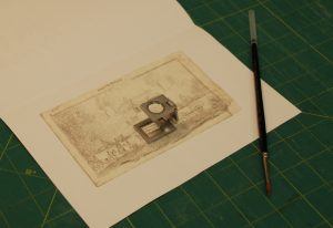 Repair work being done on a 19th century drawing