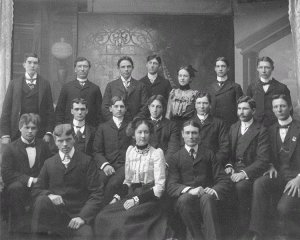 Black and white photo of a dozen students, two of who are women